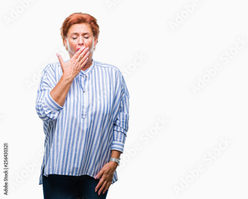 Atrractive senior caucasian redhead woman over isolated background bored yawning tired covering mouth with hand. Restless and sleepiness.