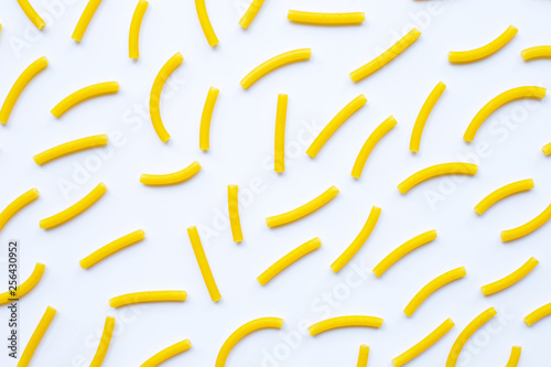 Uncooked macaroni on a white background.