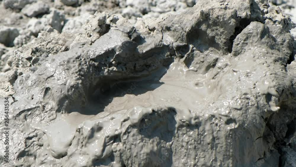 Crater of mud volcano bursting bubbles with natural gas. Famous nature landmark of Gobustan area near Baku in Azerbaijan Crater of mud volcano bursting bubbles with natural gas. Famous nature landmark of Gobustan area near Baku in Azerbaijan