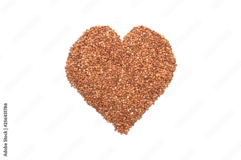 Buckwheat on a white background laid out in the form of a heart. Buckwheat on a white background laid out in the form of a heart.
