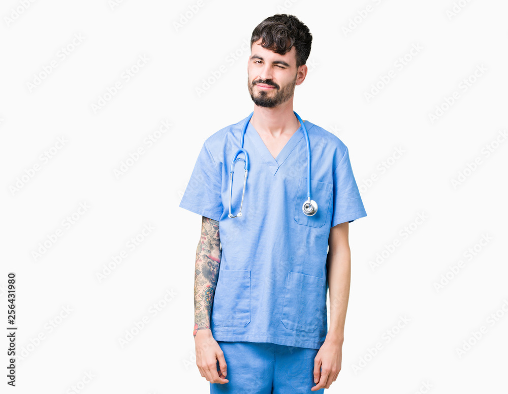 Young handsome nurse man wearing surgeon uniform over isolated background winking looking at the camera with sexy expression, cheerful and happy face. Young handsome nurse man wearing surgeon uniform over isolated background winking looking at the camera with sexy expression, cheerful and happy face.