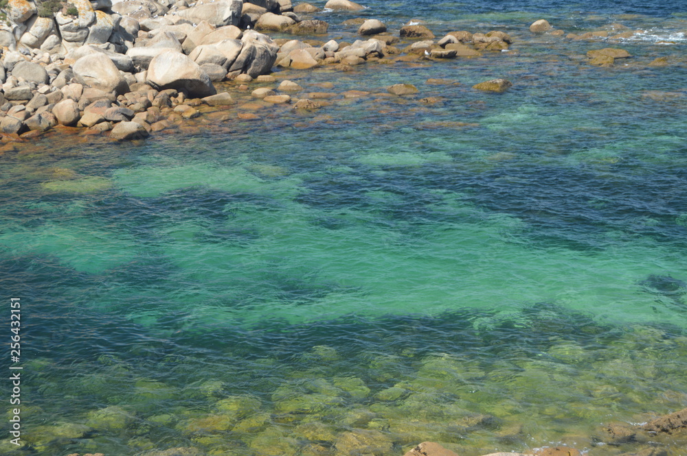 Turquoise Waters Surrounding The Fort Of The Hermitage At La Lanzada In Noalla. Nature, Architecture, History. August 19, 2014. Noalla, Pontevedra, Galicia, Spain.