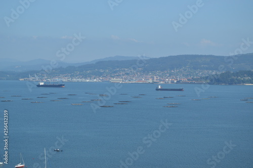 Raxo Bay With The Mussel And Oil Boats Breeding Through It. Nature, Architecture, History. August 19, 2014. Raxo, Pontevedra, Galicia, Spain.