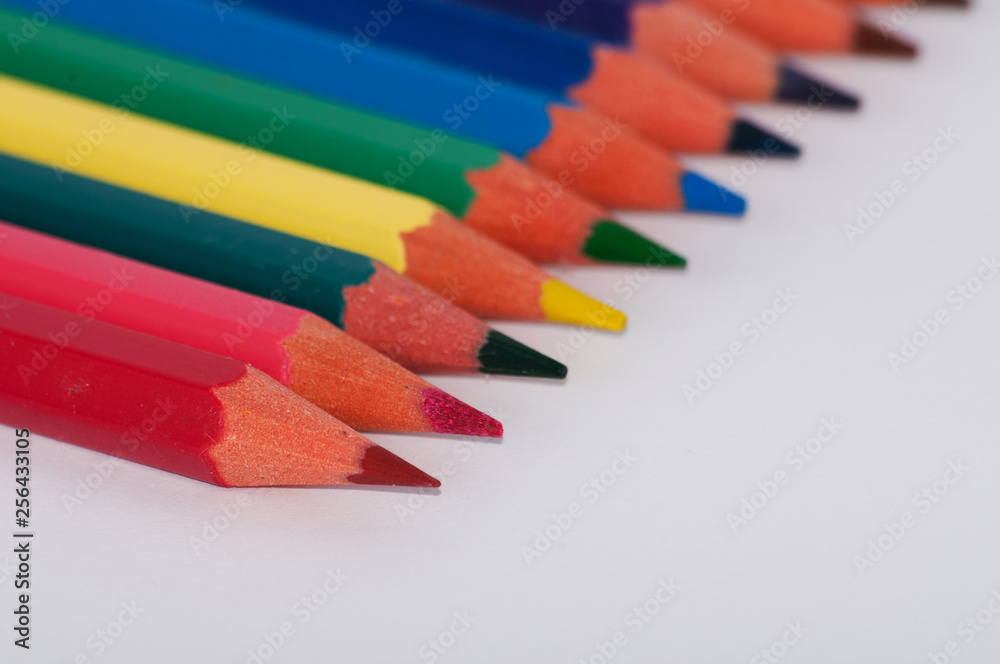 Color pencils on a white background close-up, macro, side view Color pencils on a white background close-up, macro, side view
