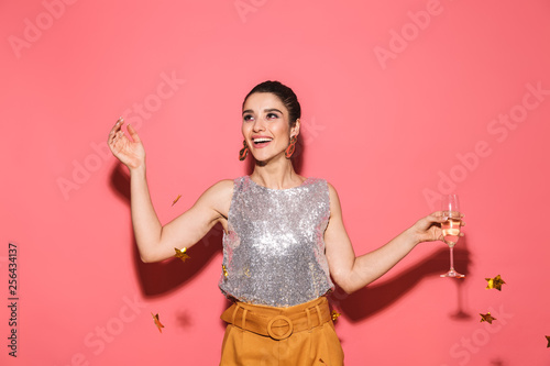 Photography Portrait of seductive woman 20s in stylish outfit drinking champagne on party un