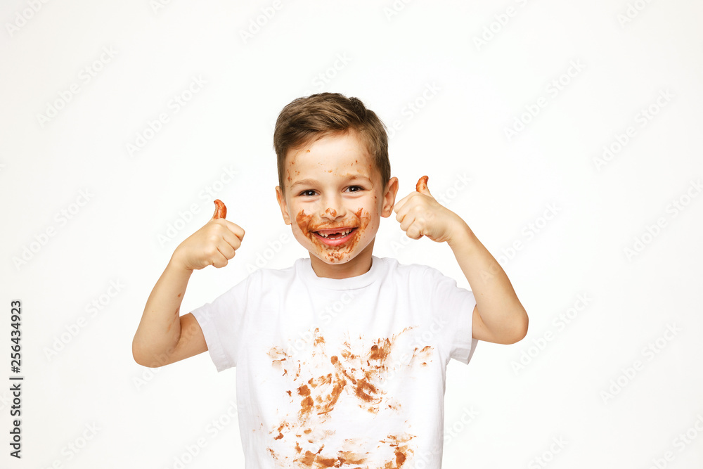 little boy with face and hands in chocolate little boy with face and hands in chocolate