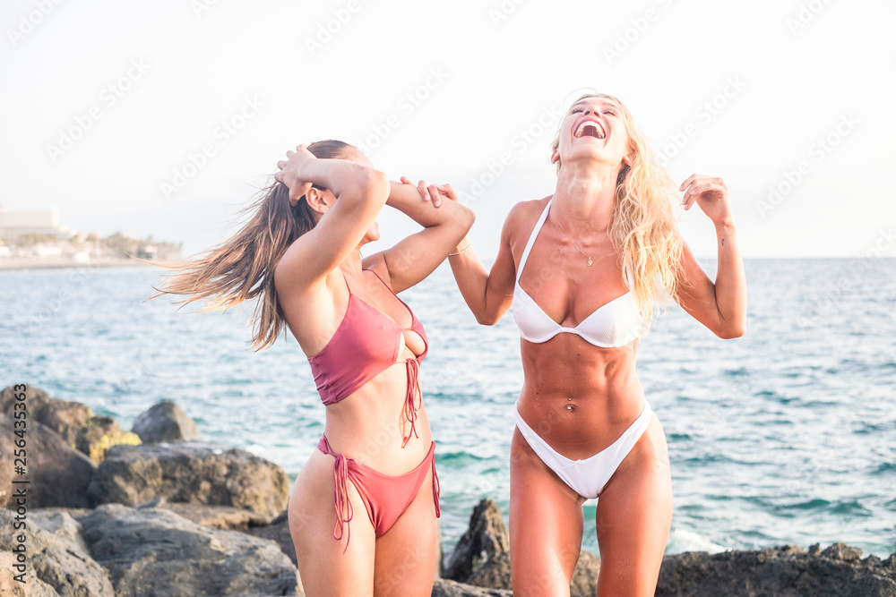 Girls with fitness abs abdominal have fun and laugh a lot together