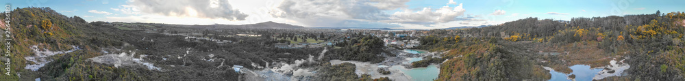 Te Puia National Park in New Zealand. Panoramic aerial view of Geysers at sunset Te Puia National Park in New Zealand. Panoramic aerial view of Geysers at sunset