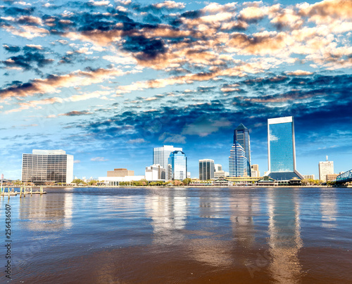 Downtown Jacksonville and St Johns River from Southbank Riverwalk. Beautiful water reflections on a sunny day