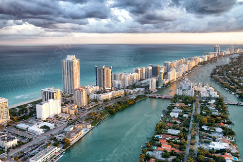 Skyscrapers of Miami Beach. Stunning aerial view at sunset with cloudy sky © jovannig