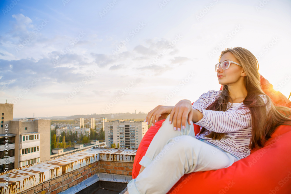 Young woman relaxing on the city rooftop