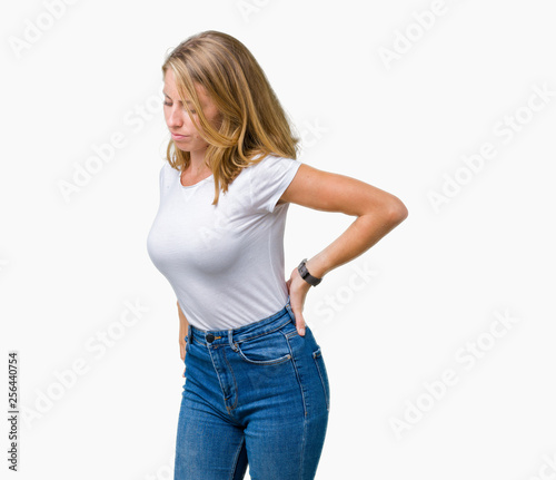 Beautiful young woman wearing casual white t-shirt over isolated background Suffering of backache, touching back with hand, muscular pain © Krakenimages.com