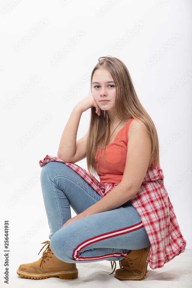 Portrait of crouching on his heels beautiful girls