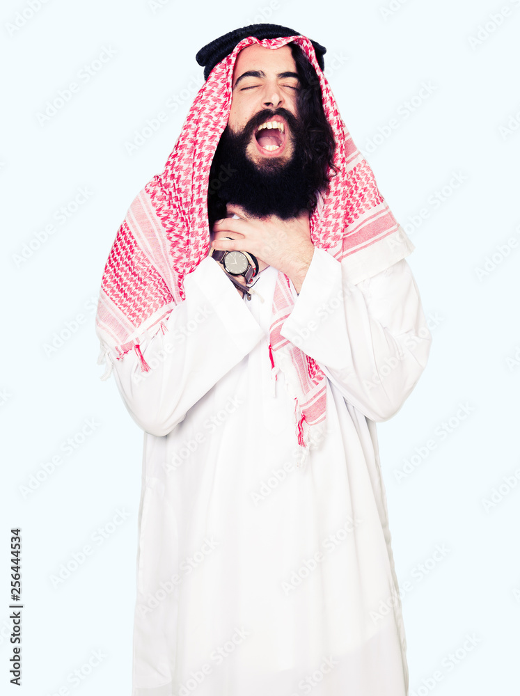 Arabian business man with long hair wearing traditional keffiyeh scarf shouting and suffocate because painful strangle. Health problem. Asphyxiate and suicide concept. Arabian business man with long hair wearing traditional keffiyeh scarf shouting and suffocate because painful strangle. Health problem. Asphyxiate and suicide concept.