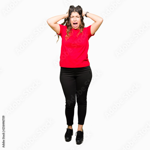 Young beautiful woman wearing casual t-shirt Crazy and scared with hands on head, afraid and surprised of shock with open mouth