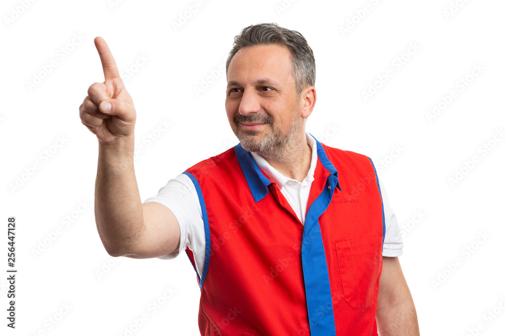 Male employee at supermarket pointing at copyspace. Male employee at supermarket pointing at copyspace.
