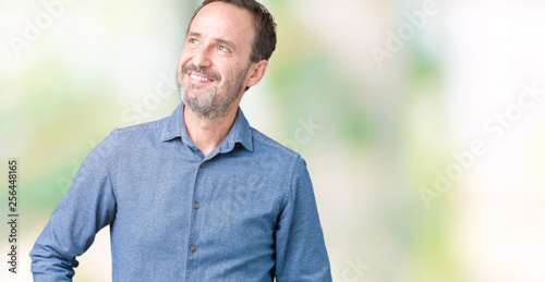 Handsome middle age elegant senior man over isolated background smiling looking side and staring away thinking.