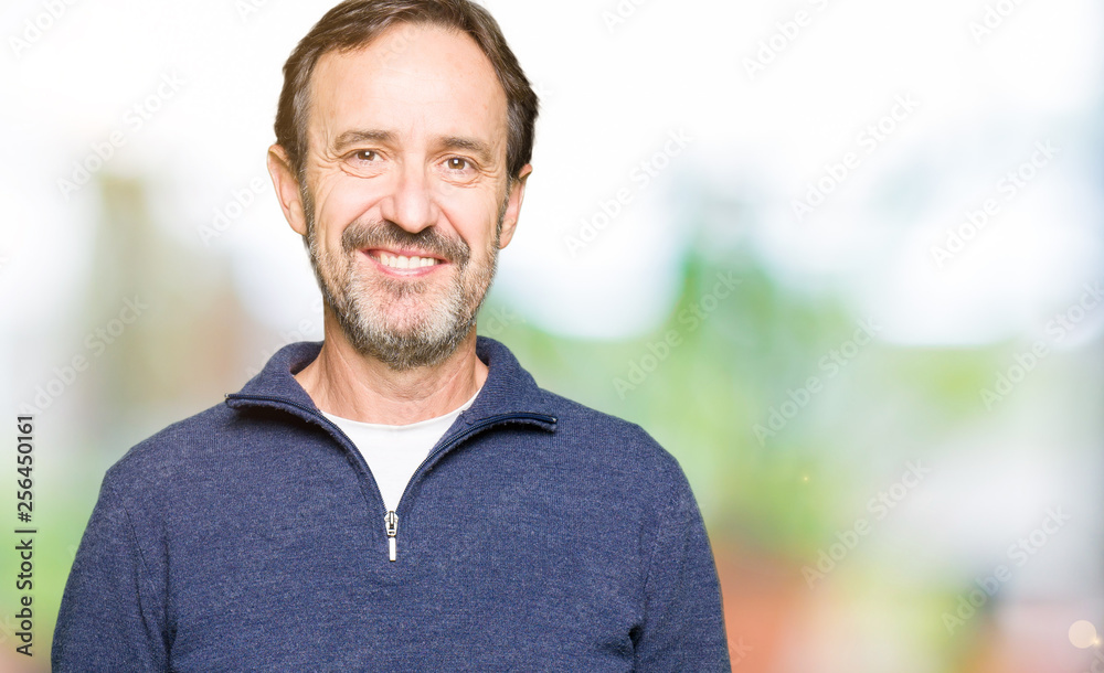 Middle age handsome man wearing a sweater with a happy and cool smile on face. Lucky person. Middle age handsome man wearing a sweater with a happy and cool smile on face. Lucky person.