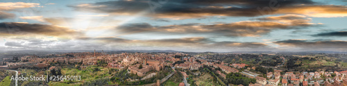Amazing panoramic aerial view of Siena medieval skyline at sunset, Tuscany.
