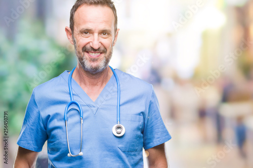 Middle age hoary senior doctor man wearing medical uniform over isolated background with a happy and cool smile on face. Lucky person.