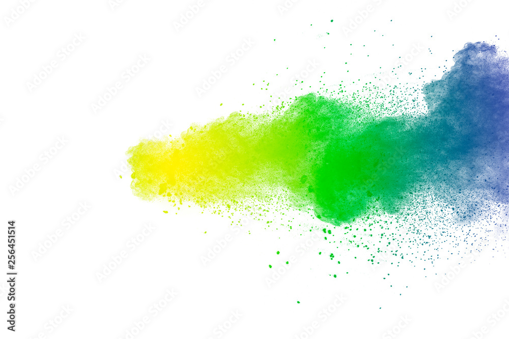 Colorful powder explosion on white background.Abstract blue yellow green  color dust particles splash.