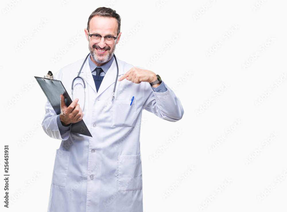Middle age senior hoary doctor man holding clipboard over isolated background with surprise face pointing finger to himself Middle age senior hoary doctor man holding clipboard over isolated background with surprise face pointing finger to himself