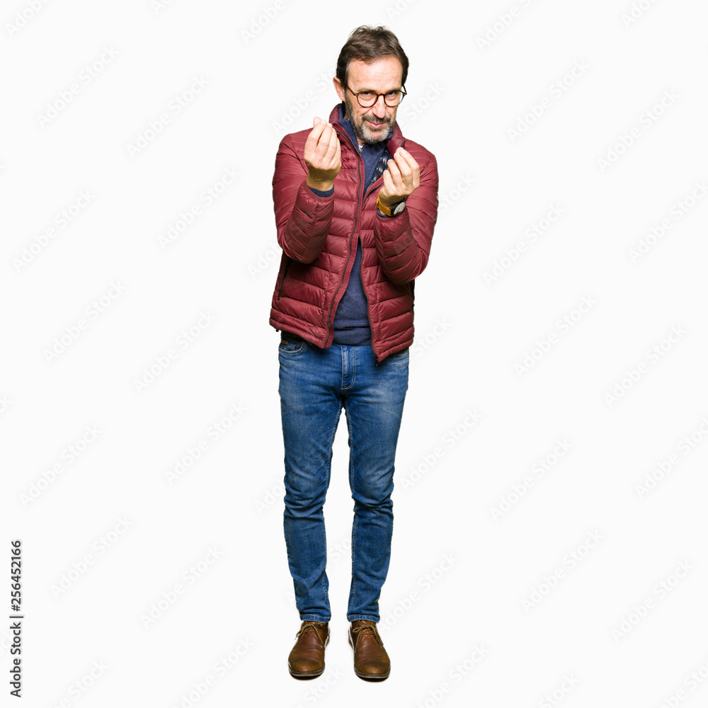 Middle age handsome man wearing glasses and winter coat Doing money gesture with hand, asking for salary payment, millionaire business Middle age handsome man wearing glasses and winter coat Doing money gesture with hand, asking for salary payment, millionaire business