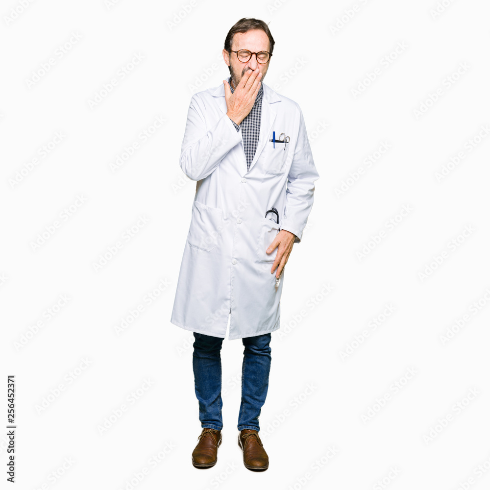 Middle age doctor men wearing medical coat bored yawning tired covering mouth with hand. Restless and sleepiness. Middle age doctor men wearing medical coat bored yawning tired covering mouth with hand. Restless and sleepiness.