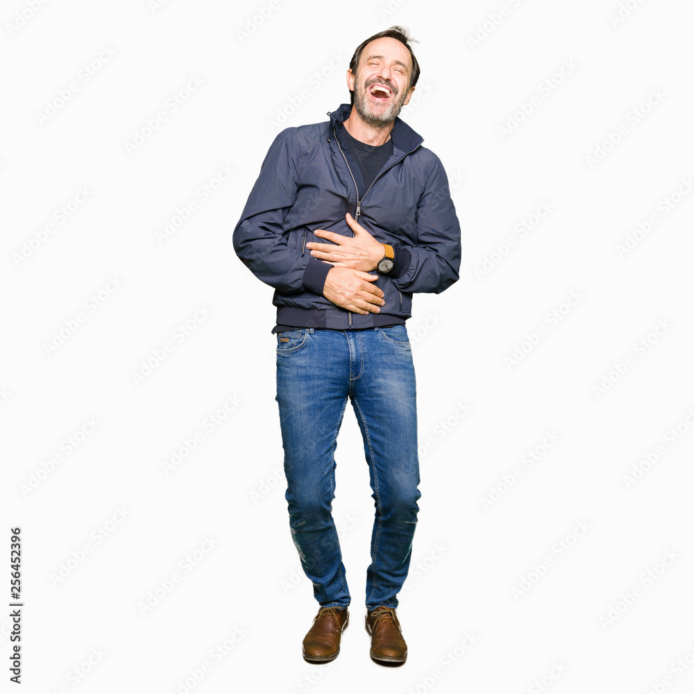 Fototapeta premium Middle age handsome man wearing a jacket Smiling and laughing hard out loud because funny crazy joke. Happy expression.
