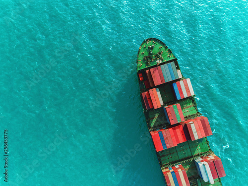 Aerial top view container ship on deep green sea delivery container for logistics, import export, shipping or transportation. © Pawinee