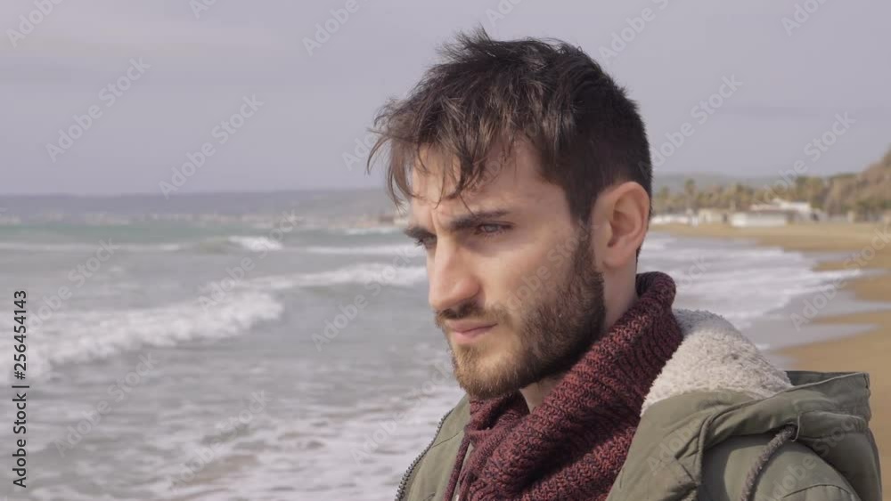 pensive worried lonely attractive man on the beach.Loneliness,thoughts,problems