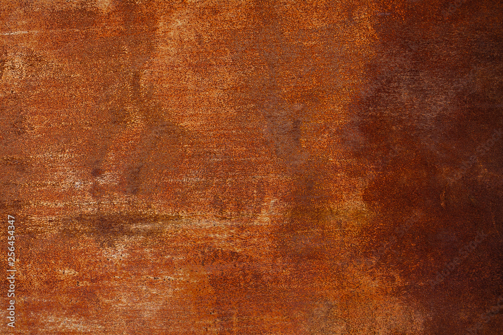 Rusty yellow-red textured metal surface. The texture of the metal sheet is prone to oxidation and corrosion. Textured background in grunge Style Rusty yellow-red textured metal surface. The texture of the metal sheet is prone to oxidation and corrosion. Textured background in grunge Style