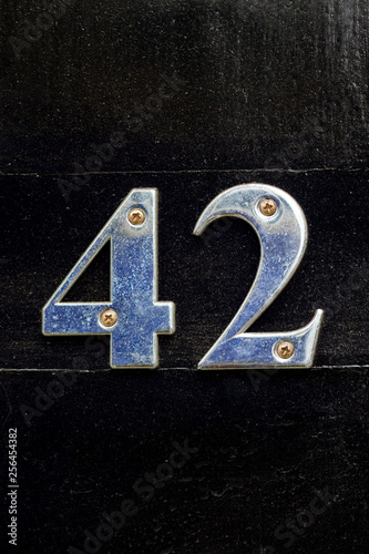 House number 42 seen close up with the the forty two in silver metal  photo