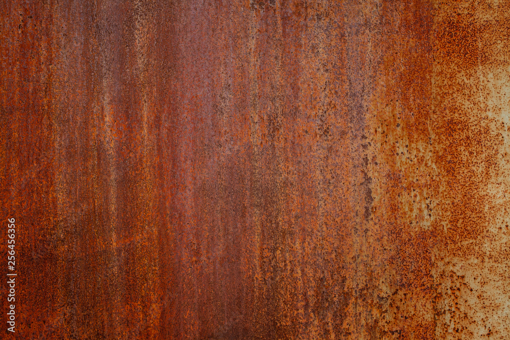 Rusty yellow-red textured metal surface. The texture of the metal sheet is prone to oxidation and corrosion. Textured background in grunge Style