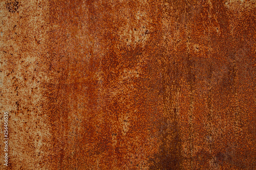 Rusty yellow-red textured metal surface. The texture of the metal sheet is prone to oxidation and corrosion. Textured background in grunge Style