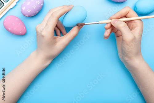 Hands holding a painted egg