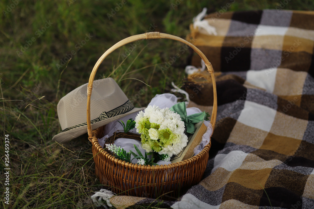 basket with flowers on wooden table basket with flowers on wooden table