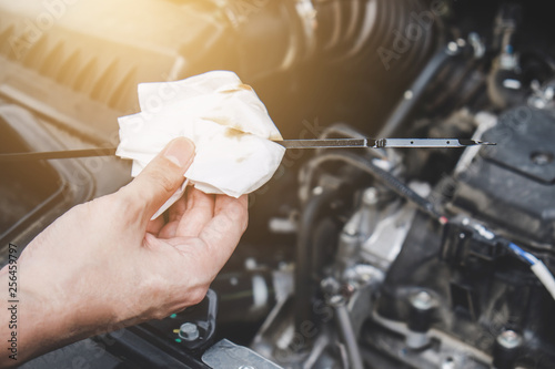 Services car engine machine concept, Automobile mechanic repairman hands checking a car engine automotive with oil level in the engine transportation, car service and maintenance photo