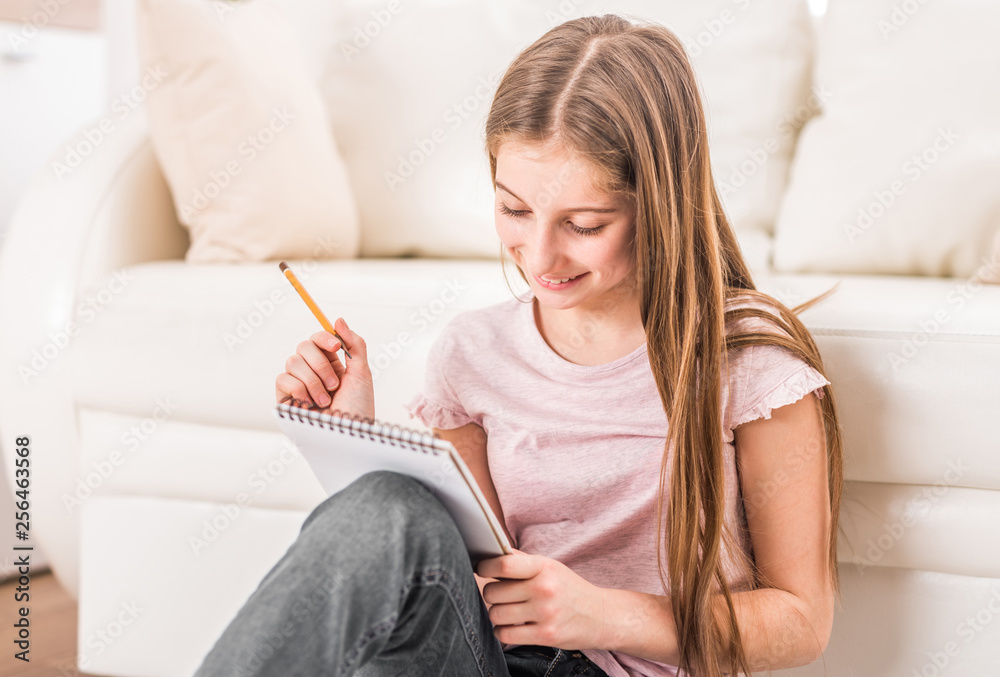 Smiling girl drawing pictures Smiling girl drawing pictures