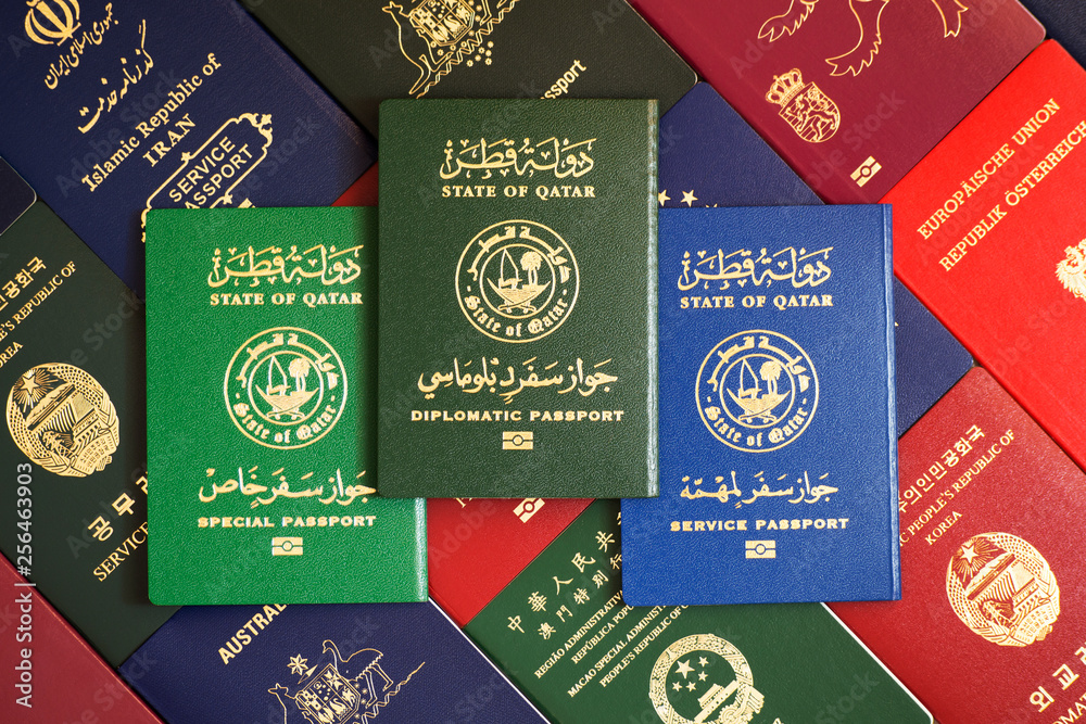 Multicolored different passports of the State of Qatar against background  of various documents of many countries of the world Stock Photo | Adobe  Stock