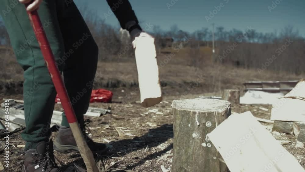 Cracking fire wood with a bad axe Cracking fire wood with a bad axe