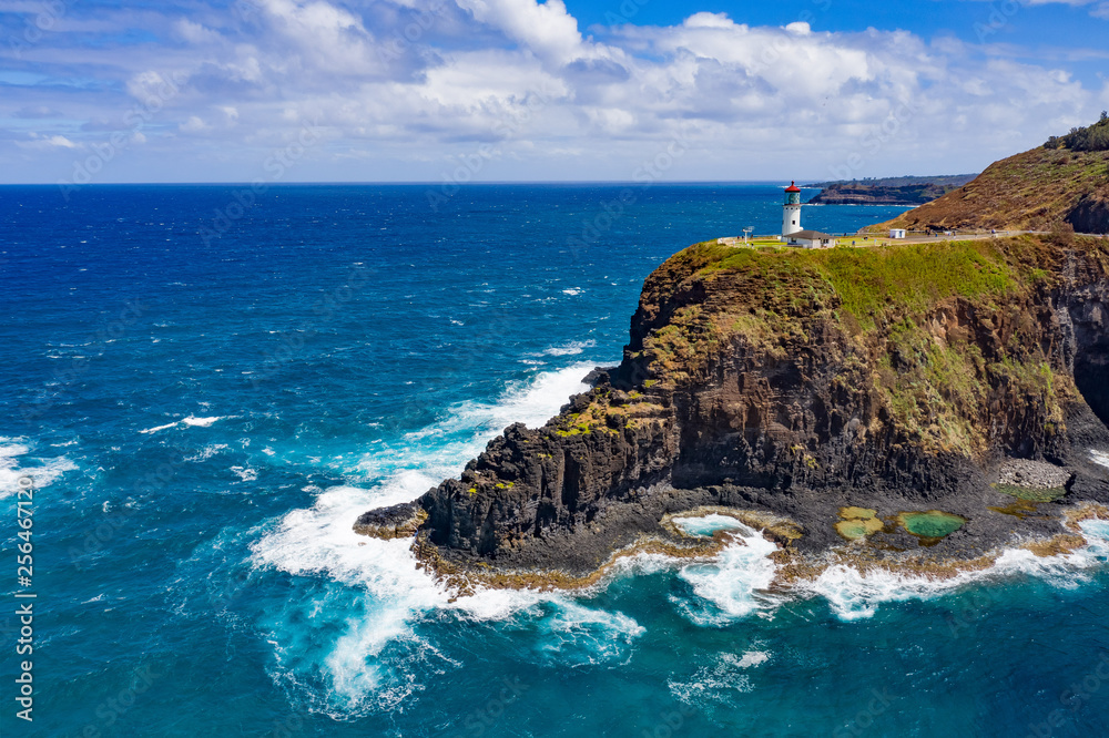 lighthouse in hawaii on rocks with coastline