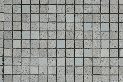 Broken grey,white and black tiles. Old,dirty and grunge background.