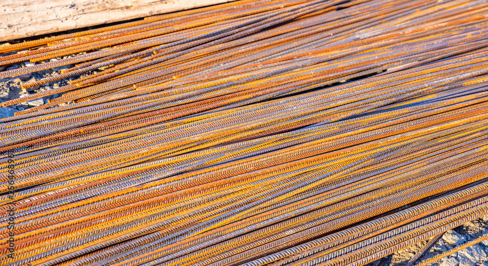 Rusty metal steel reinforcement bars, rods at a construction site Rusty metal steel reinforcement bars, rods at a construction site