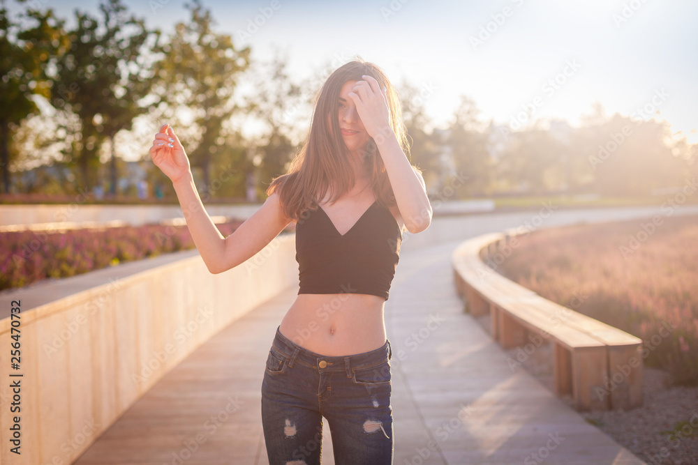 Girl, jeans pants with holes, black t-shirt, street Girl, jeans pants with holes, black t-shirt, street