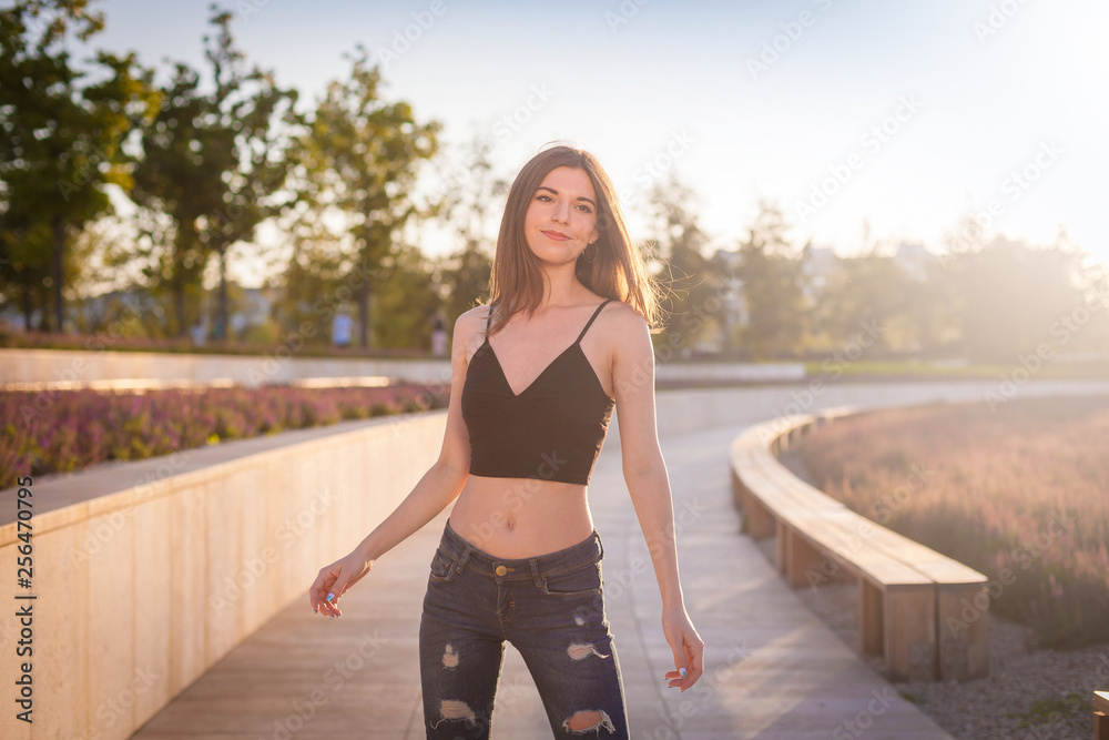  Girl, jeans pants with holes, black t-shirt,  street