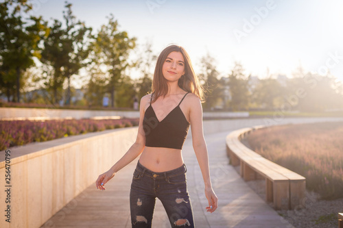  Girl, jeans pants with holes, black t-shirt, street