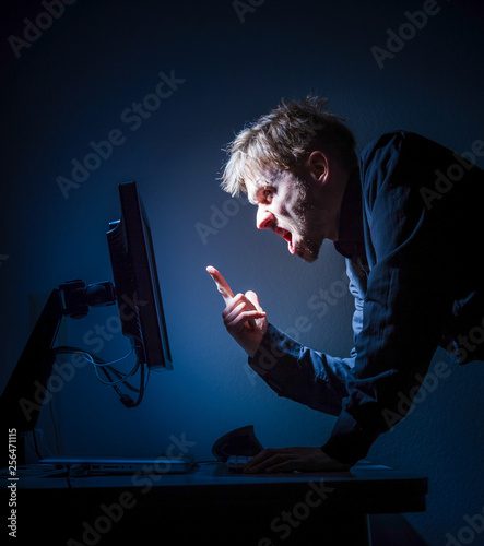 Fotografie, Obraz Angry Young Man pointing at at Computer Screen