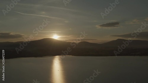Wallpaper Mural Aerial drone shot of lonely boat on huge lake at sunset with mountains in background Torontodigital.ca
