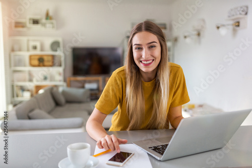 Young woman using her laptop at home 